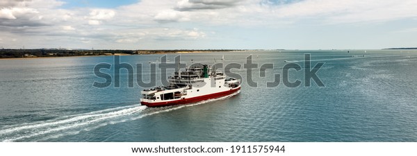 Banner - Car\
ferry in Southampton Water on a beautiful sunny day with clouds in\
the blue sky. Space for\
text.