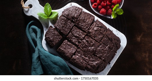 Banner Of Chocolate Vegan Brownie Pie With Tahini And Fresh Raspberries On A Dark Background