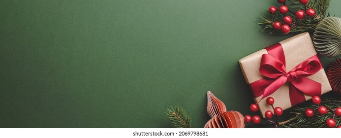 Banner with Christmas gift and decorations on olive background. - Shutterstock ID 2069798681