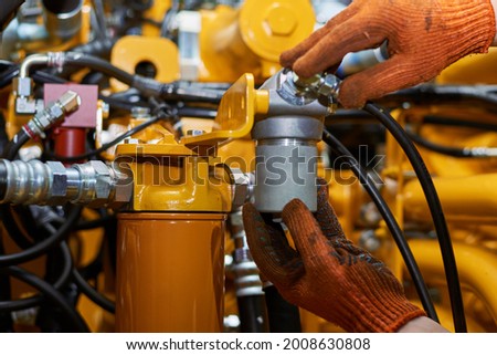 Banner with close up view of hydraulic pipes of heavy industry machine. Low key. Hydraulic maintenance concept.