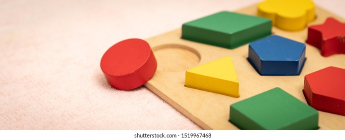 Banner closeup of colorful wooden Montessori sensorial material learning, Shape and color block. Kindergarten educational toys, Thinking process, Cognitive skills, Learn Through Play tools concept.