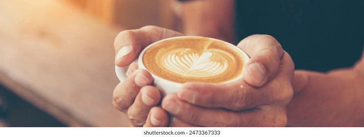 Banner Coffee barista pour espresso shot and make latte art hot coffee cup. Cappuccino with milk in italian coffee shop cafe. Banner Close up hands of barista make brown latte art with copy space - Powered by Shutterstock