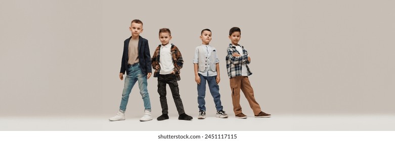 Banner. Cool attitude little boys, elementary pupils posing against grey studio background with negative space to insert text. Concept of kid's fashion and beauty, style, school shopping. Black Friday - Powered by Shutterstock