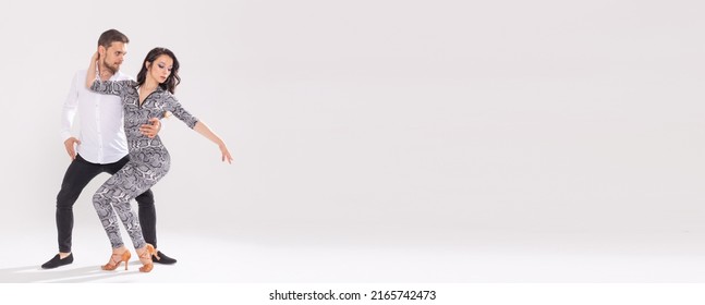 Banner couple dancing social latin dance bachata, merengue, salsa. Two elegance pose on white background with copyspace