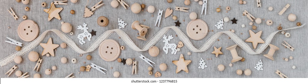 Banner Craft And Wooden Christmas Flatlay On Farbic Background. Wooden Supplies, Cotton Lace And Christmas Symbols. Place For Text