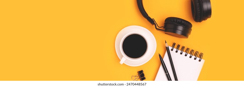 Banner with cup of coffee, headphones and stationery on a yellow background.  - Powered by Shutterstock