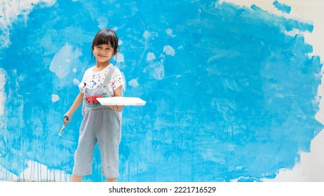 Banner Of Cute 5 Years Old Asian Little Girl Is Smiling While Painting The Wall With Water Color At Home, Concept Of Art Education For Kid, Homeschooling And Learning Activity By Playing For Child.