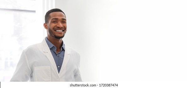 Banner For Dental Clinic. Portrait Of Young Black Guy Dentist Posing In Clinic, Panorama With Copy Space