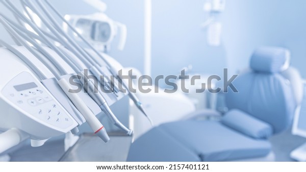 Banner dentists room office. Closeup\
different dental instruments and tools, blue\
toning.