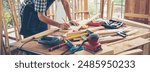 Banner DIY craftsperson asian man working wood heap carpenter objects woodwork desk. Banner Architect man hands ruler measure home improvement. Wood carpenter construction workshop with copy space