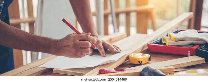 Banner DIY craftsperson asian man working wood heap carpenter objects woodwork desk. Banner Architect man hands ruler measure home improvement. Wood carpenter construction workshop with copy space - Powered by Shutterstock