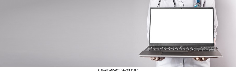 Banner with doctor holding laptop mockup. Online medical consultation, using computer at work and study, telehealth, telemedicine concept. Copy space. High quality photo