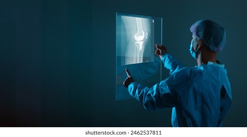 Banner of a Doctor looking at the x-ray knee. copy space. - Powered by Shutterstock