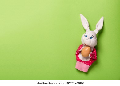 Banner With Easter Bunny Keeping The Egg On Green Background With Copy Space, Empty Text Place. Christian Holiday Card. Springtime. Online Course Learning Of Toy Theater. Painting Eggs. Hand Puppet.