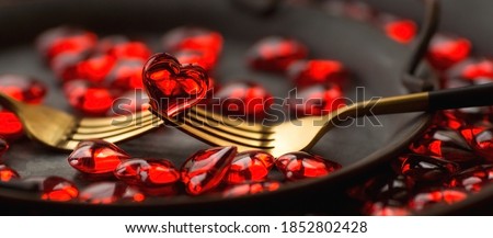 Banner. Festive table setting.Heart on a fork close-up. Holiday concept. Valentine's Day. Copy space for inscriptions.