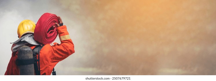 Banner Firefighter Rescue team training in fire fighting. Panorama Teamwork Firefighter fighting flame using fire hose chemical water foam spray. Fireman teams safety uniform hard hat with copy space