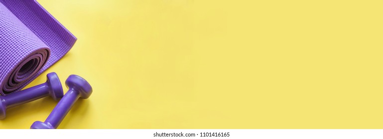 Banner of fitness concept with dumbbells, and a mat, on a yellow background.