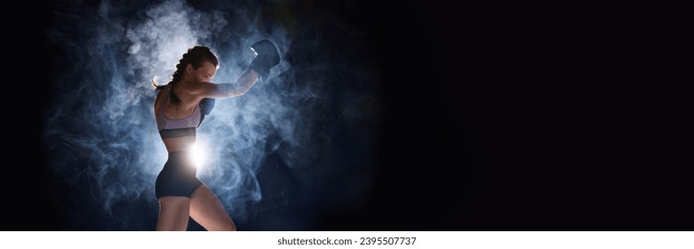 Banner. Flyer. Focused and powerful, female sportsman gearing up for battle, against black studio background in stage smoke. Negative space for text. Concept of sport, active lifestyle, competition. - Powered by Shutterstock