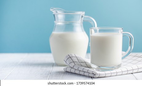  Banner of a glass of milk, a jug of milk on blue background. The concept of farm dairy products, milk day. Copy space. - Shutterstock ID 1739574104