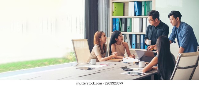 Banner Group of business people meeting in conference room. Panorama Asian businesspeople brainstorm teamwork partnership. Happy teams meeting graph chart business data meeting room with copy space