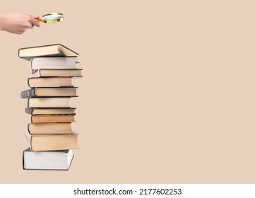 Banner with hand holding magnifying glass over books stack. Information search and analysis, research conducting. Data study for preparing for exams. Student lifestyle concept. Copy space. photo