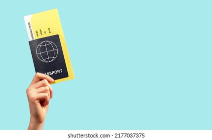 Banner with hand holding passport and boarding pass on turquoise background. Documents for travelling by plane. Tourism, air trip concept. Copy space. High quality photo - Shutterstock ID 2177037375