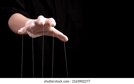 Banner with hand in medical glove with strings on fingers. Deception in medicine and pharmacy, conspiracy theory, health care fraud, negative impact on patient concept. Copy space. High quality photo