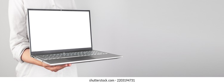 Banner with hands holding laptop mockup. Person showing presentation at business meeting. Using computer technologies at work. Place for text. High quality photo - Shutterstock ID 2203194731