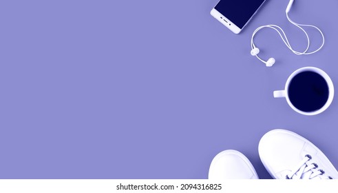 Banner. Healthy lifestyle concept using color 2022 Very Peri. Sports composition with sneakers, smartphone, earphones and coffee on violet background. Sports flatlay. Top view. Copy space.  - Powered by Shutterstock