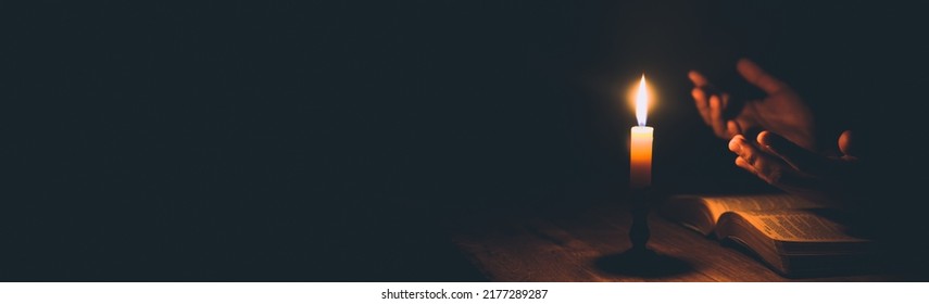 Banner image of Candle with bible on a old oak wooden table. Beautiful gold background. Religion concept. - Shutterstock ID 2177289287