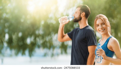 Banner image of happy smile, couple holding plastic water bottles, woman and man, bearded coach trainer, after successful morning training, sunrise outdoors. Fitness, sport, workout ad concept. - Powered by Shutterstock