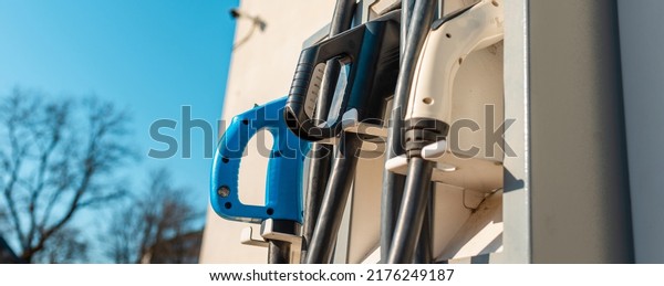Banner image.power cord for electric car.\
Green station.Power supply for electric car battery\
charging.Selective\
focus.Closeup.