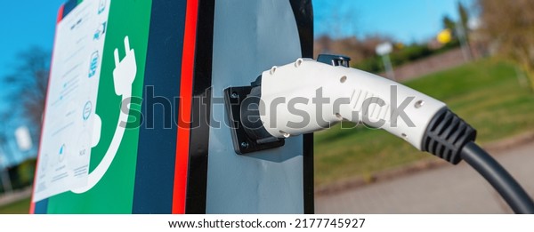 Banner image.power cord for electric car.
Green station.Power supply for electric car battery
charging.Selective
focus.Closeup.