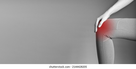 Banner With Knee Pain. Woman Holding Painful Leg With Red Spot Closeup. Arthritis, Tendonitis, Injuries. Health Care, Orthopedic Problems And Medicine Concept. Copy Space. Black And White. Photo