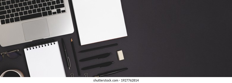 Banner With Laptop And Office Supply On A Black Background. Online Business Organized Workspace, Distance Work Concept With Open Notepad Mockup.