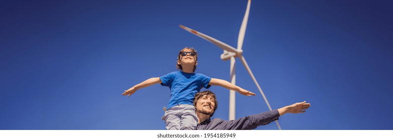 BANNER, LONG FORMAT Alternative energy, wind farm and happy time with your family. Happy father carrying his son on shoulders is on vacation and escape to nature. Father carrying son on shoulders and