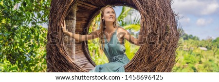 BANNER, LONG FORMAT Bali trend, straw nests everywhere. Young tourist enjoying her travel around Bali island, Indonesia. Making a stop on a beautiful hill. Photo in a straw nest, natural environment