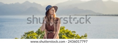 BANNER, LONG FORMAT Happy woman tourist on background of Antalya sea and mountain views, sea in Turkey Antalya City. female tourist traveler discover interesting places and popular attractions and