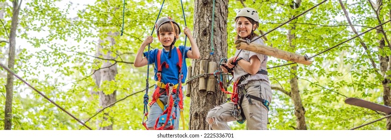 BANNER, LONG FORMAT Mother and son climbing in extreme road trolley zipline in forest on carabiner safety link on tree to tree top rope adventure park. Family weekend children kids activities concept - Powered by Shutterstock