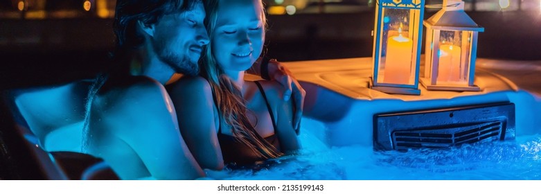 BANNER, LONG FORMAT Portrait of young carefree happy smiling couple relaxing at hot tub during enjoying happy traveling moment vacation life against the background of green big mountains at night - Powered by Shutterstock