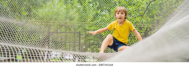 BANNER, LONG FORMAT Practice Nets Playground. Boy Plays In The Playground Shielded With A Protective Safety Net. Concept Of Children On Line, Kid In Social Networks. Blurred Background, Blurred Motion