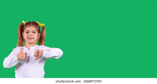 Banner, Long Format. Side Space Photo Of A School Girl In School Uniform With Two Ponytails And Yellow Ribbon On The Head Showing Hand Sign Contradiction Holding Thumbs Up And Down.