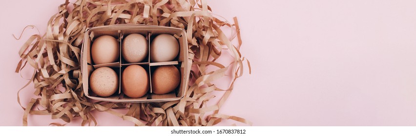 Banner Made With Farm Organic Eggs In A Wooden Basket And Paper Pack Decor On Pastel Pink Background. Zero Waste, Easter Concept. Flat Lay Style.