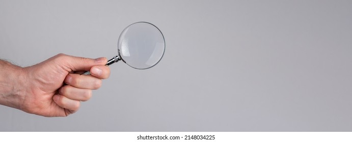 Banner with man hand with magnifying glass. Data search analysis, conducting research, nuances, important details study, preparation for exams concept. Space for text. High quality photo