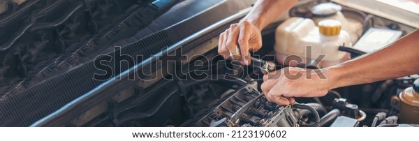 Banner Man hands fixing Car machinery vehicle\
mechanical service. Mechanic man hands repairing car shop.\
panoramaopen vehicle hood checking up auto mobile. Car maintenance\
engineer with copy\
sapce.