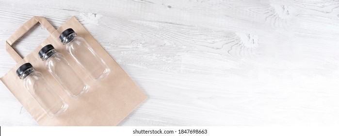 Banner. Mockup, Scene Creator. Paper Bag, Three Plastic Bottles. Eco-friendly Food Packaging And Cotton Eco Bags On Gray Background With Copy Space. Containers For Catering And Street Fast Food