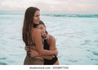 A banner with mother and teenage daughter standing on the beach against the backdrop of the ocean with turquoise water and hugging tenderly. Love for child. Mothers Day. Summer vacation with daughter. - Powered by Shutterstock