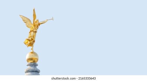 Banner with old statue of a golden angel as a warrior and defender at the dome top in downtown of Dresden, Germany, with copy space blue sky solid background