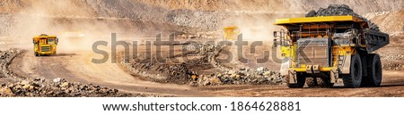 Banner open pit mine industry, big yellow mining truck for coal anthracite.