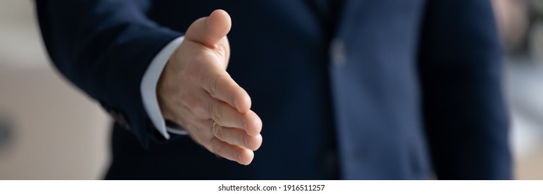Banner panoramic header view of businessman stretch hand for handshake greet get acquainted at meeting in office. Male CEO shake hand welcome newcomer at workplace. Acquaintance concept. - Shutterstock ID 1916511257